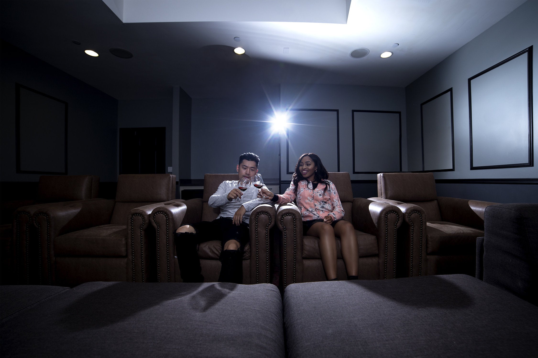 couple in home theater on zero gravity recliners