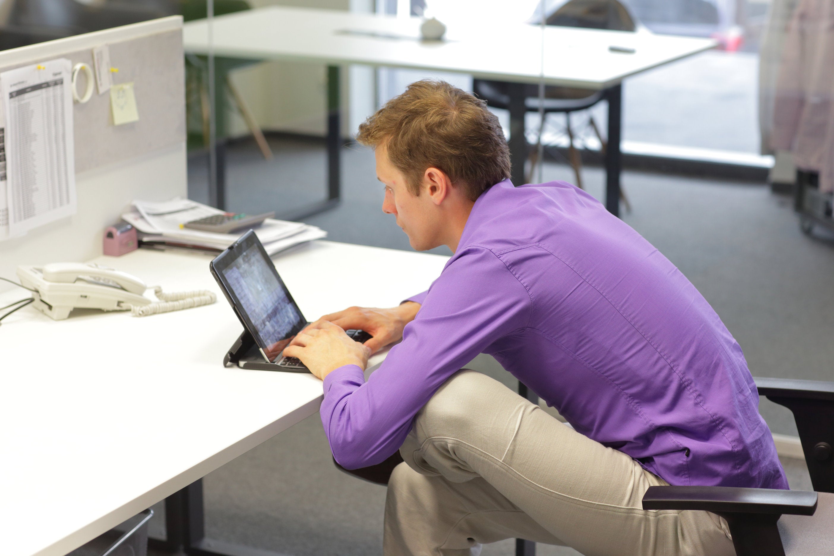 man with bad sitting habits slouching in chair