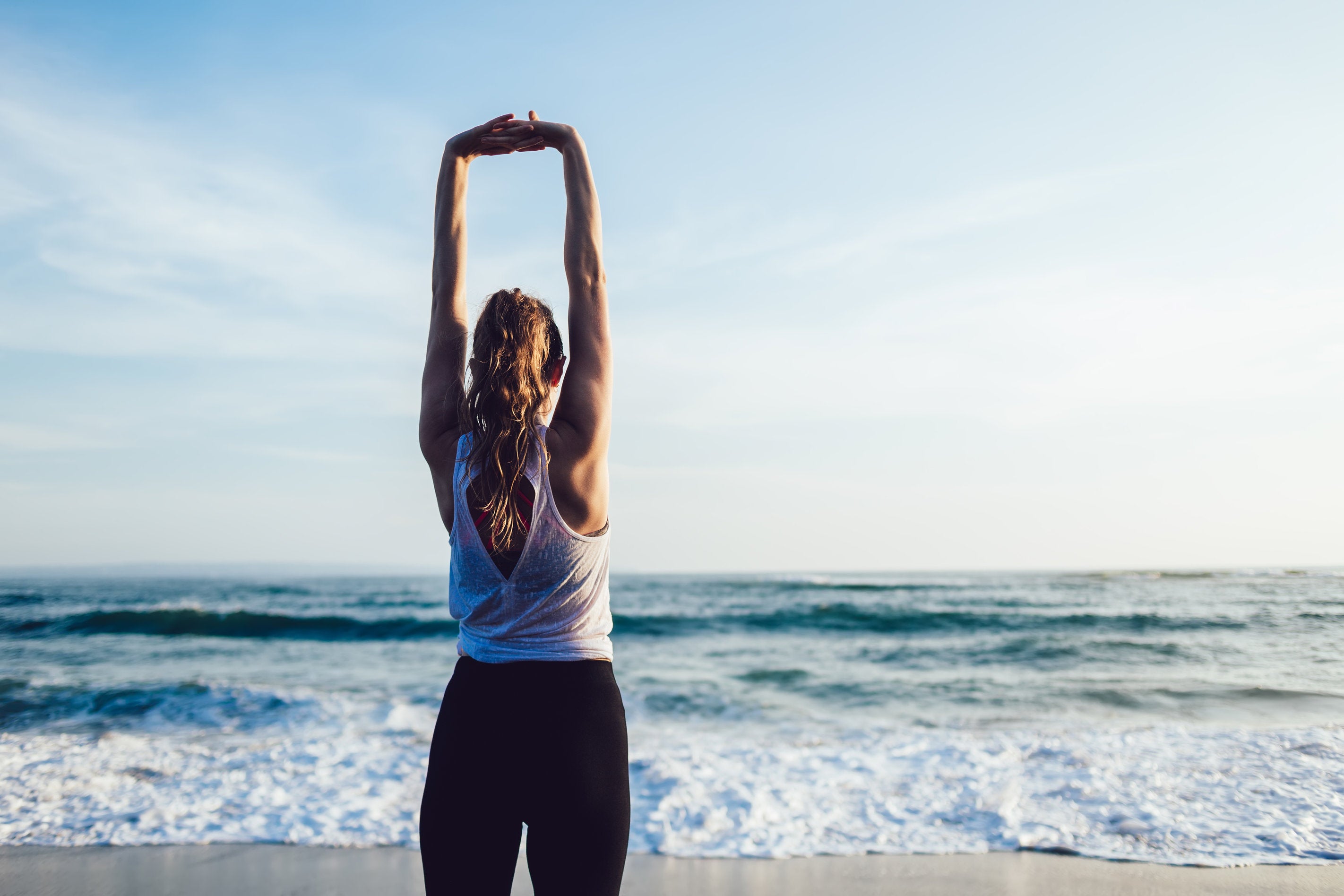 woman doing overhead stretch for spinal decompression