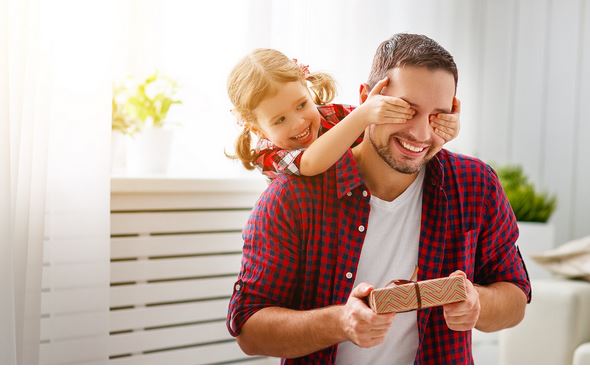 a child giving their father a fathers day gift