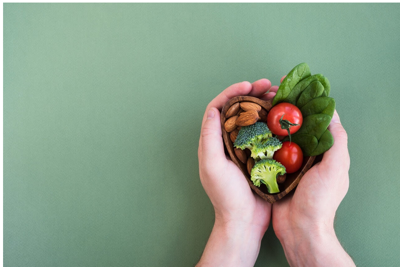a hand holding vegetables