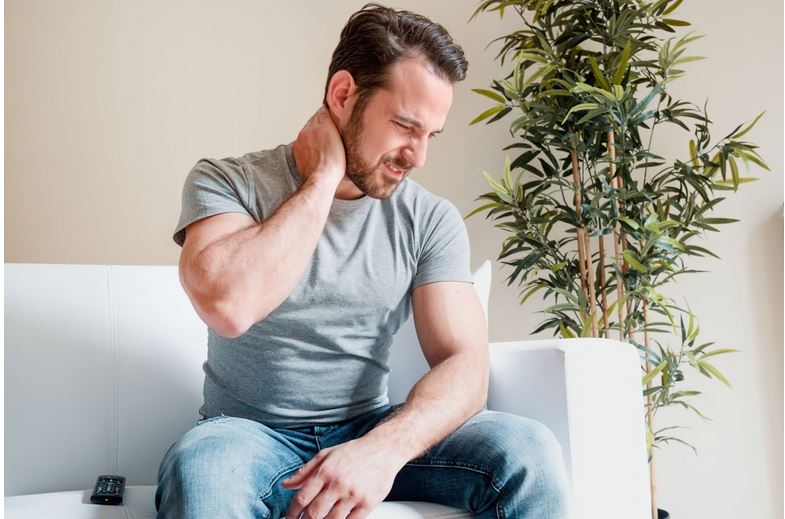  a man suffering from neck and back pain