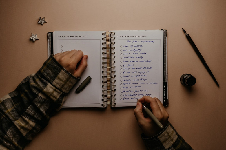 a person writing out their new year's resolutions