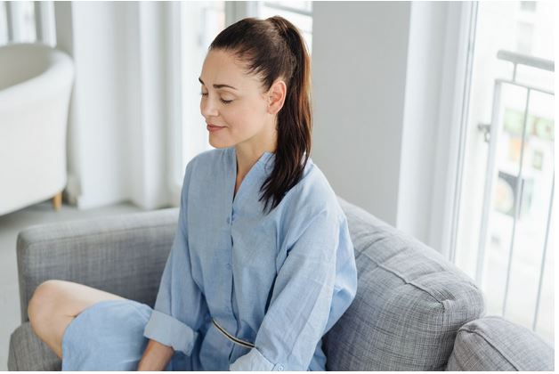 a woman meditating at home