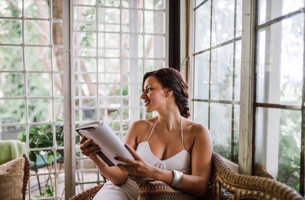 a woman relaxing in her sunroom