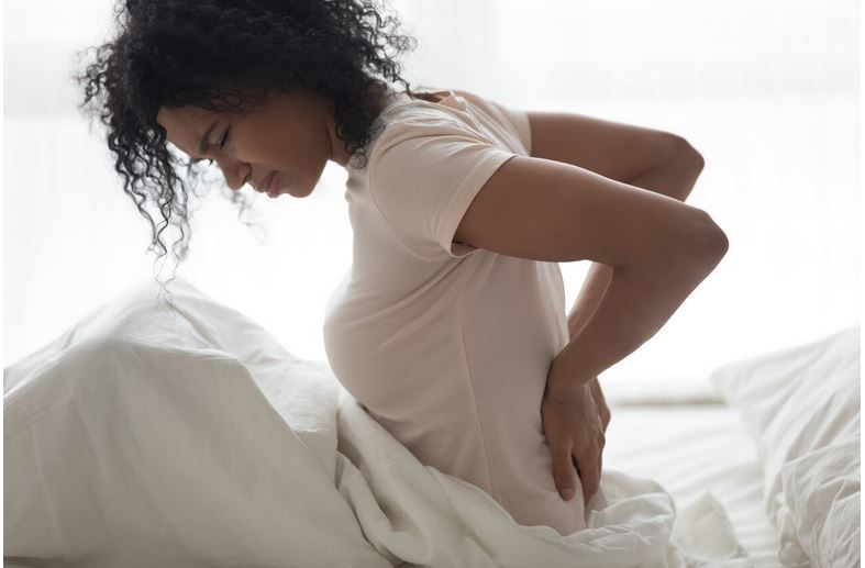 a woman suffering from back pain