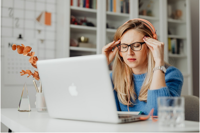a woman working from home dealing with stress
