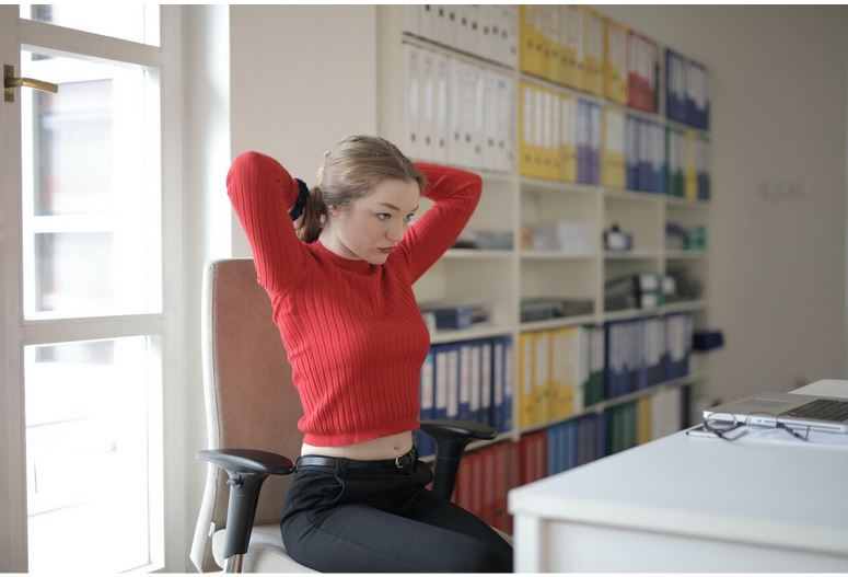 a woman doing a workout at her desk