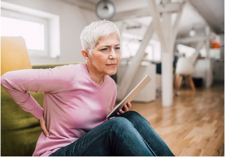 an older woman suffering form back pain