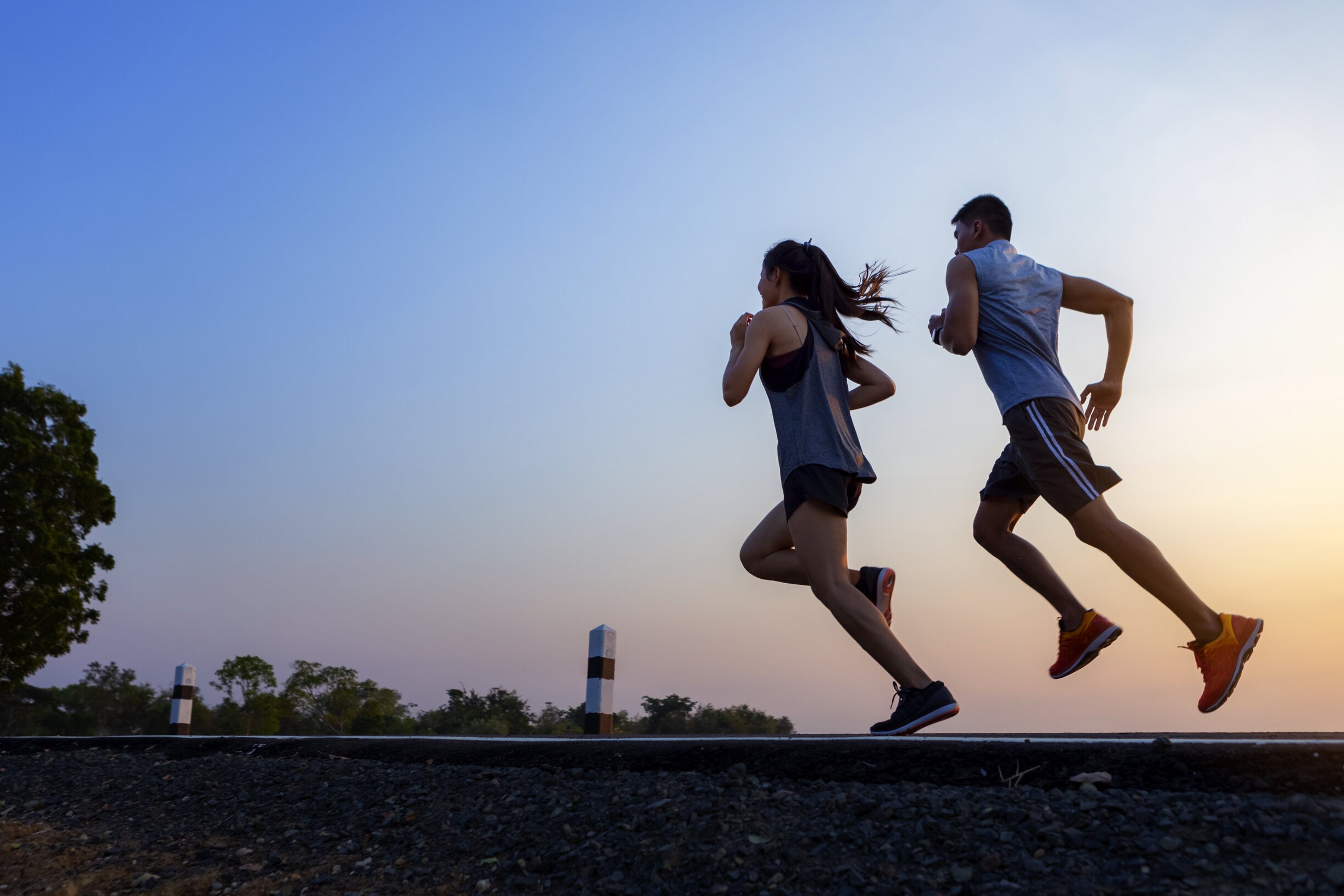 male and female fitness enthusiasts running