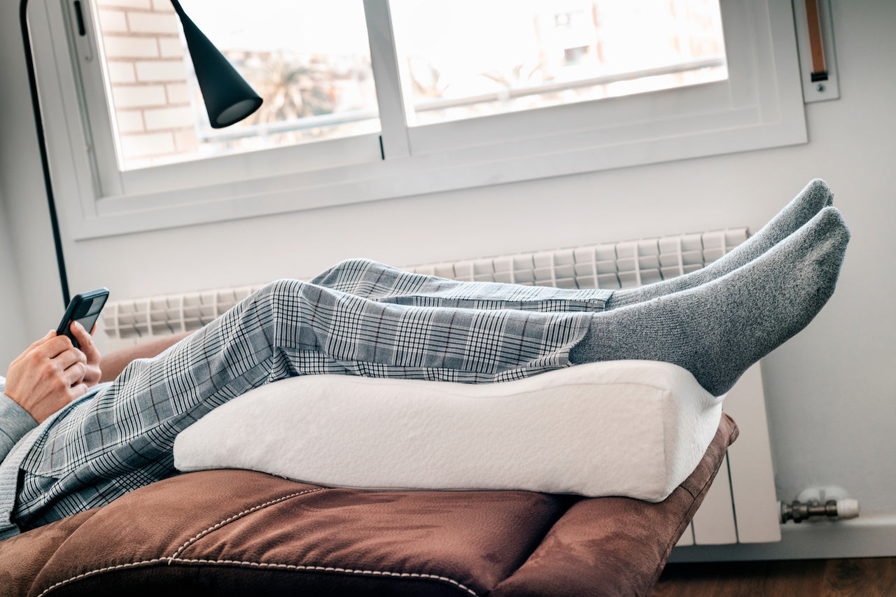 man elevating legs for health