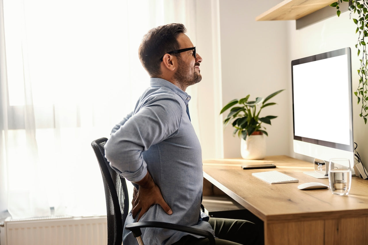 man-sitting-in-chair-for-lower-back-pain
