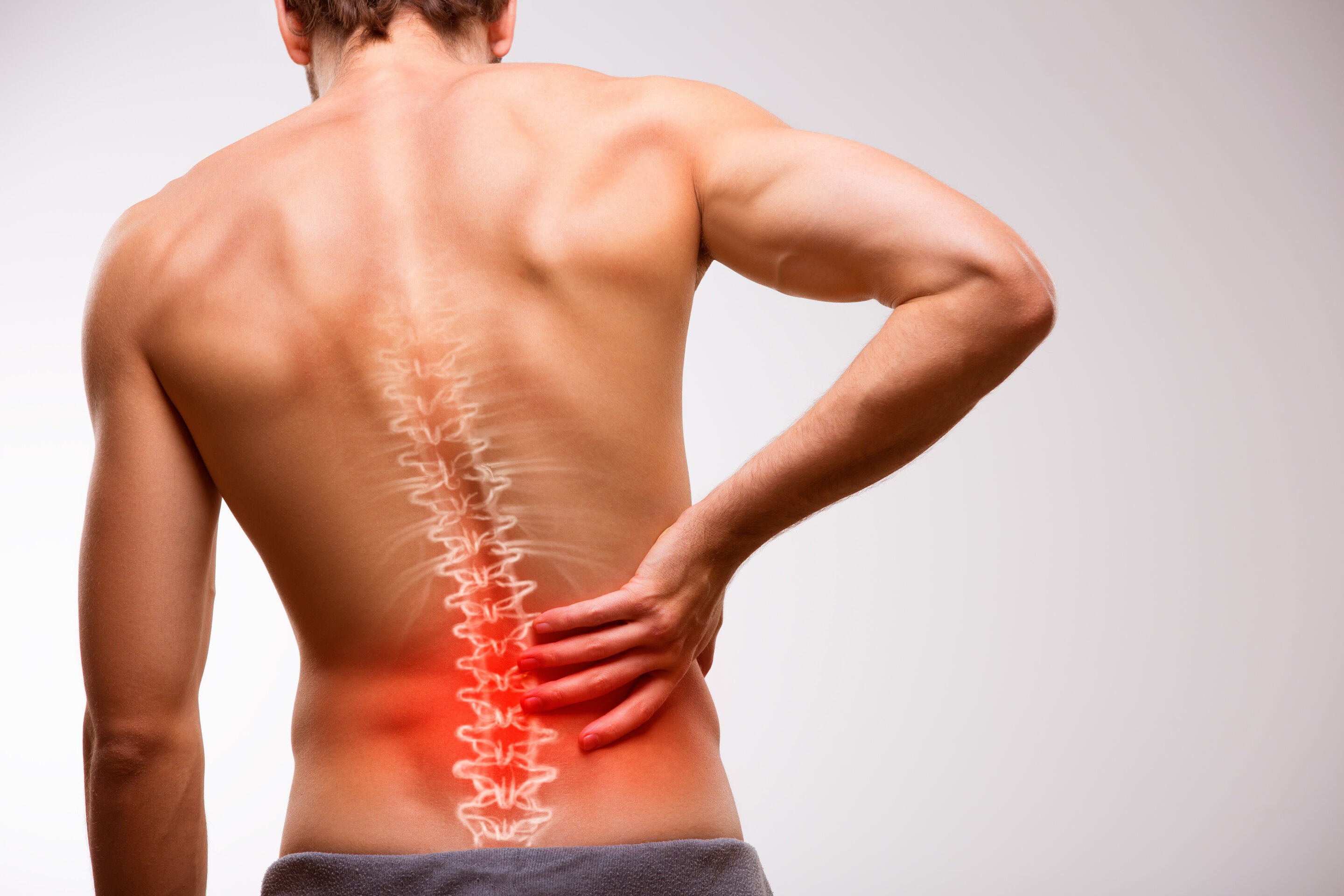 man experiencing different types of back pain