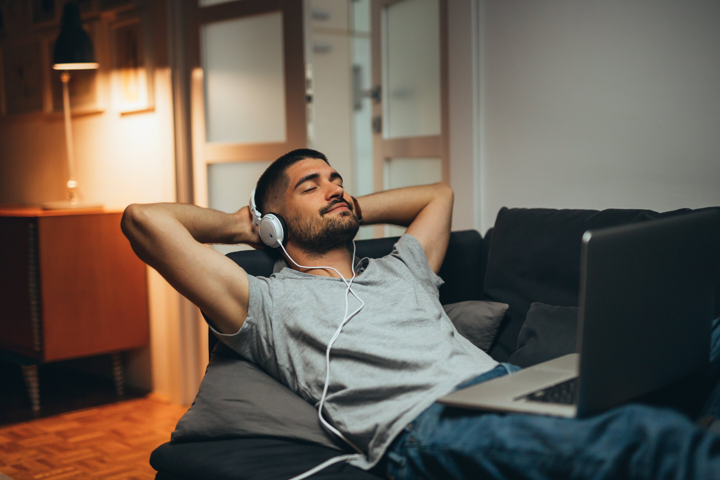 man listening to music before bed
