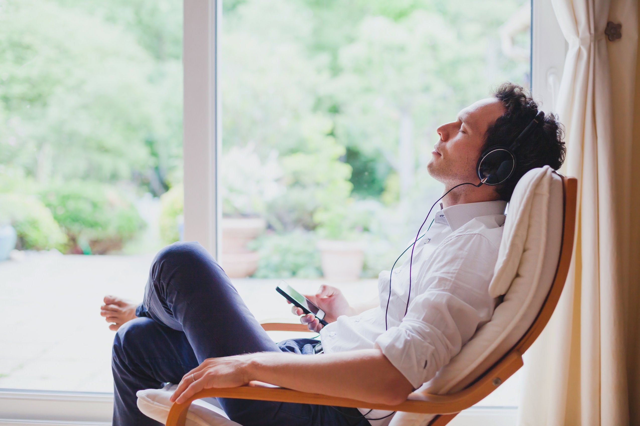 man listening to music in zero gravity chair