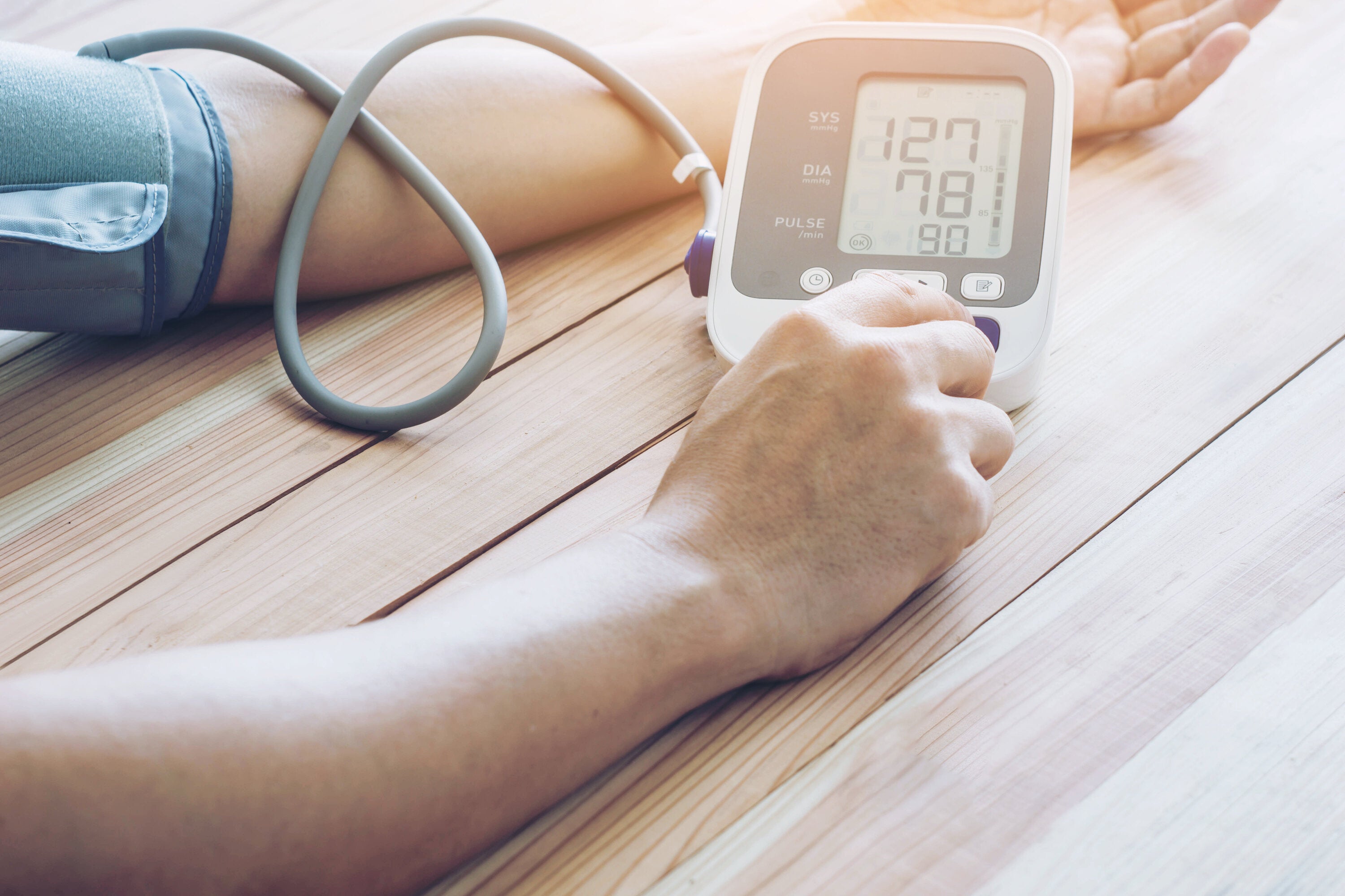 person checking blood pressure at home