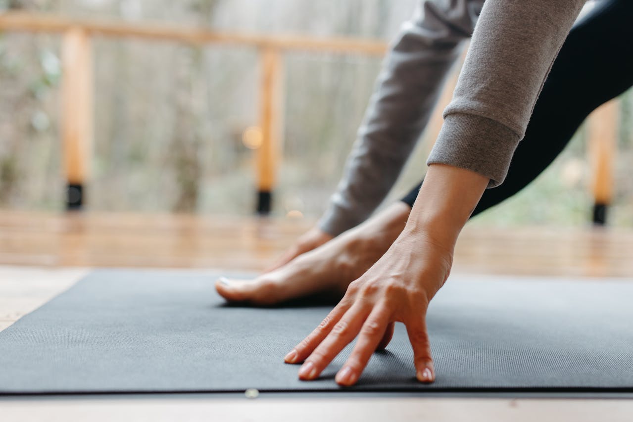 person stretching on mat for better blood circulation