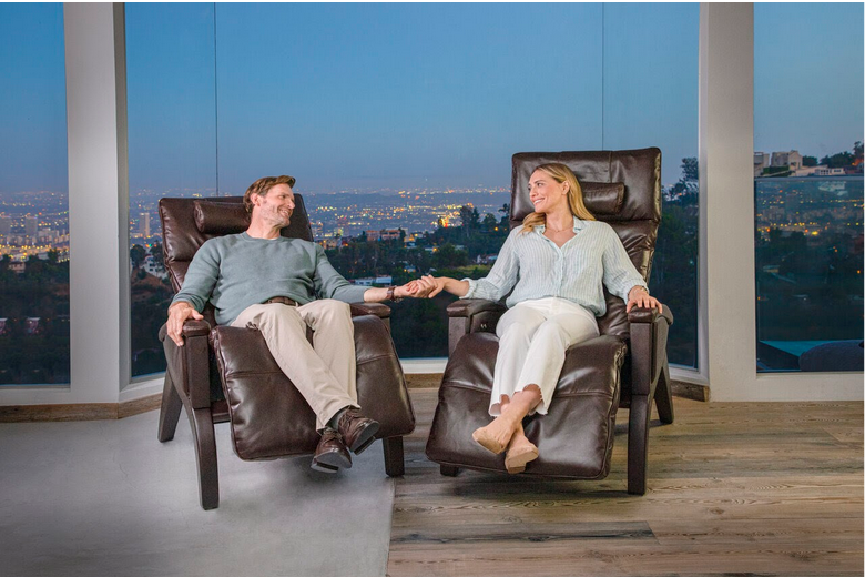 photo of a couple sitting in zero gravity chairs