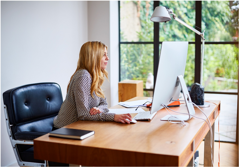 photo of a woman working at her computer