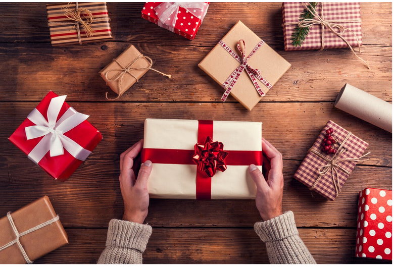 photo of a woman wrapping christmas presents