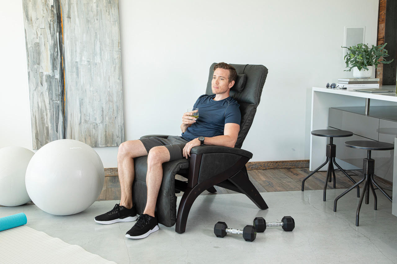 a man using a zero gravity chair for his workout