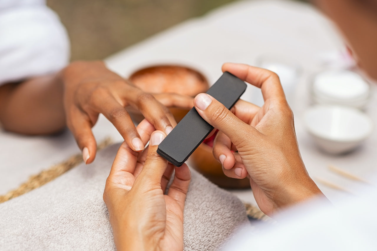 woman getting manicure in nail salon chairs