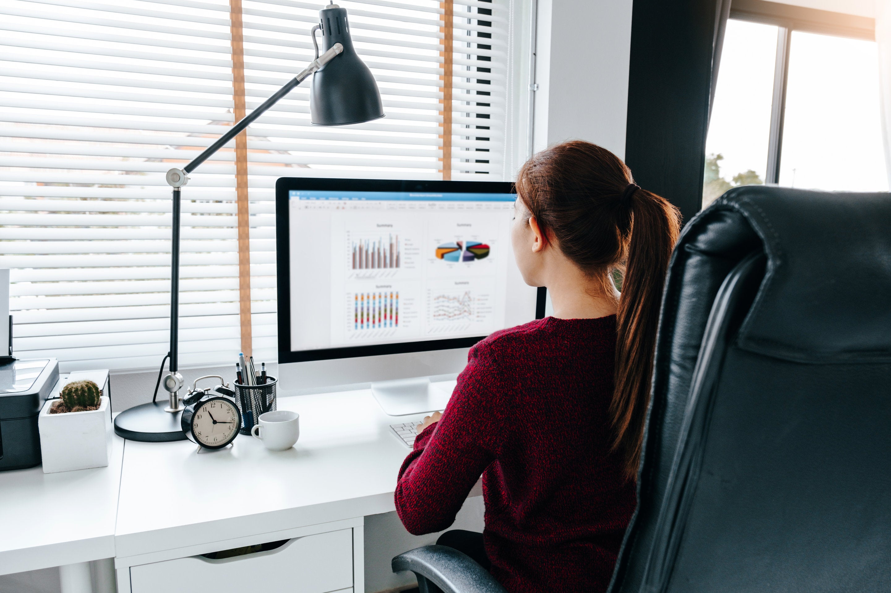 woman sitting in zero gravity chair in home office