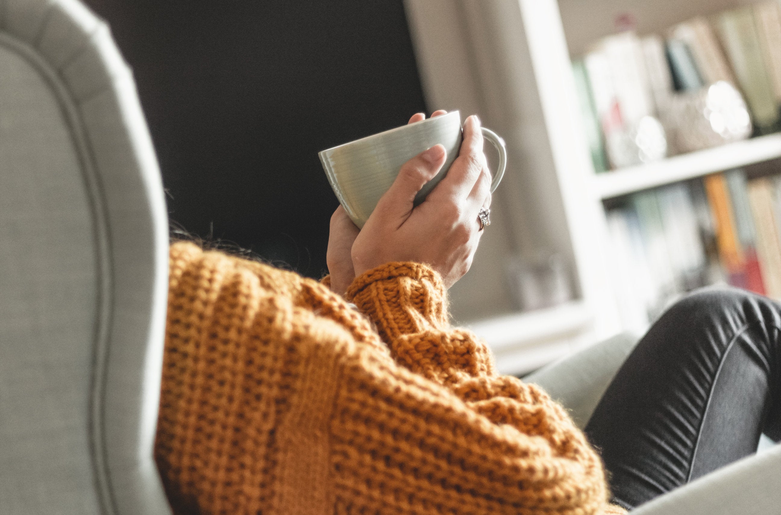 woman sitting in zero gravity chair with coffee