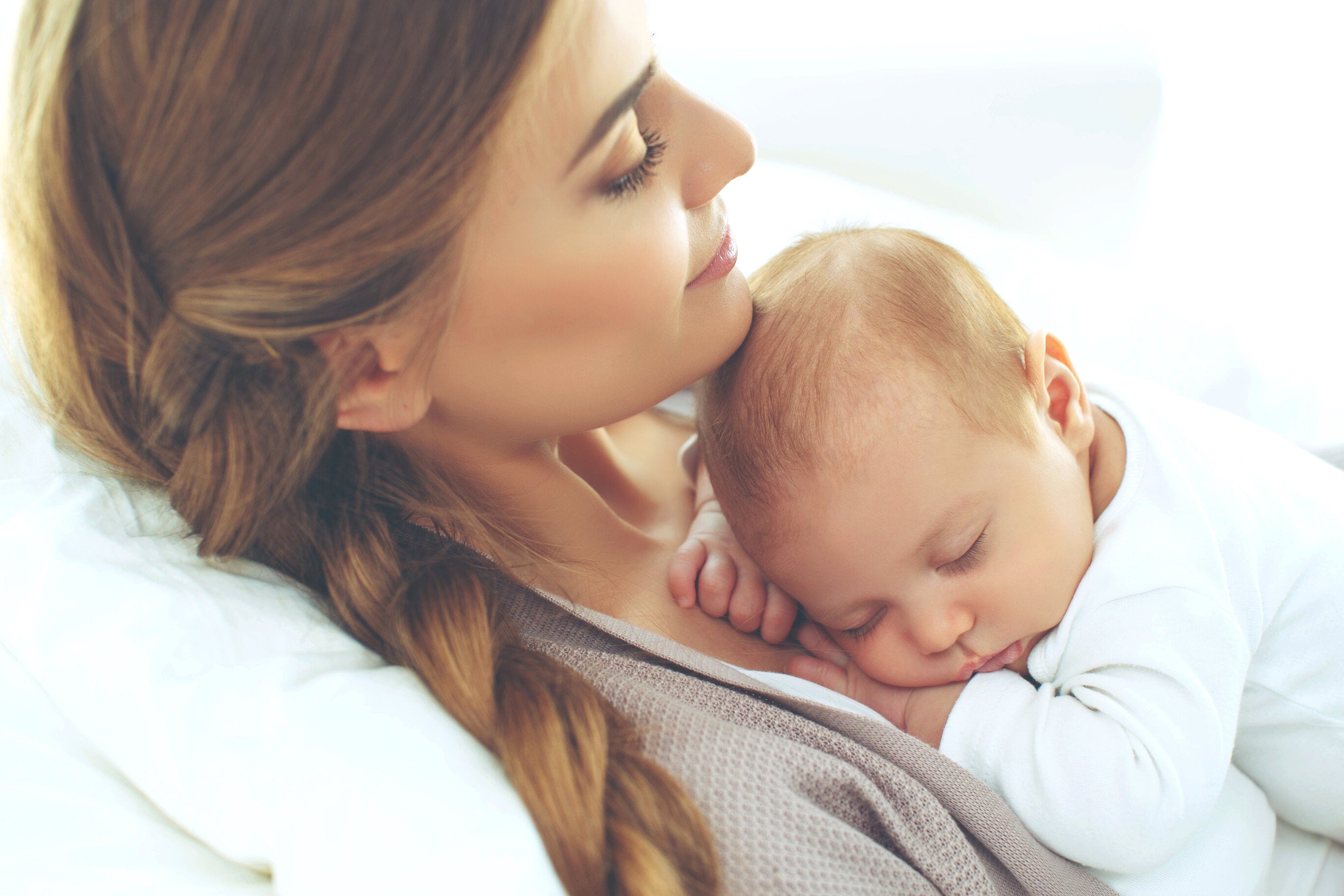woman with newborn in baby nursing chair