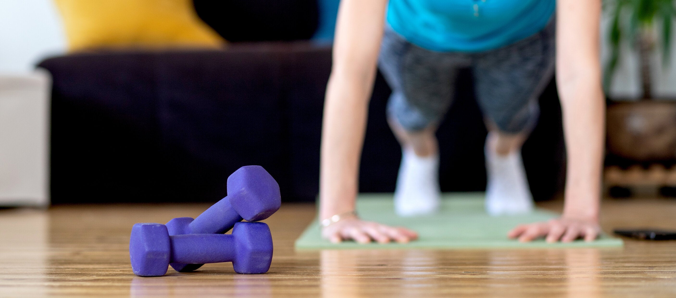 woman working out at home during COVID-19 pandemic