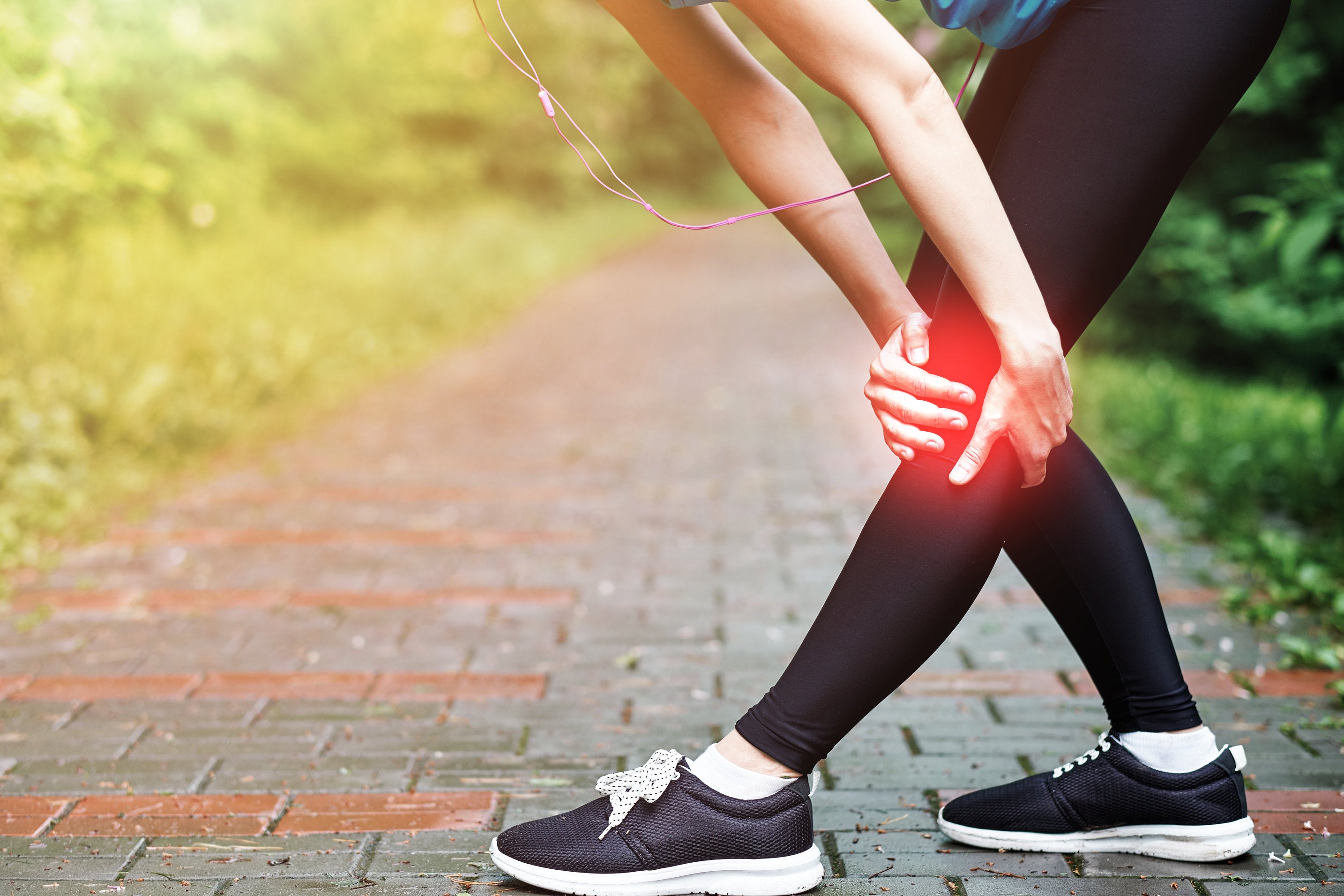 young woman with swollen joint pain in the knee