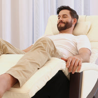 A man relaxes on a Svago Newton Zero Gravity Recliner in a bright, airy room.