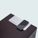 close up of phone charging on Svago ero gravity side table