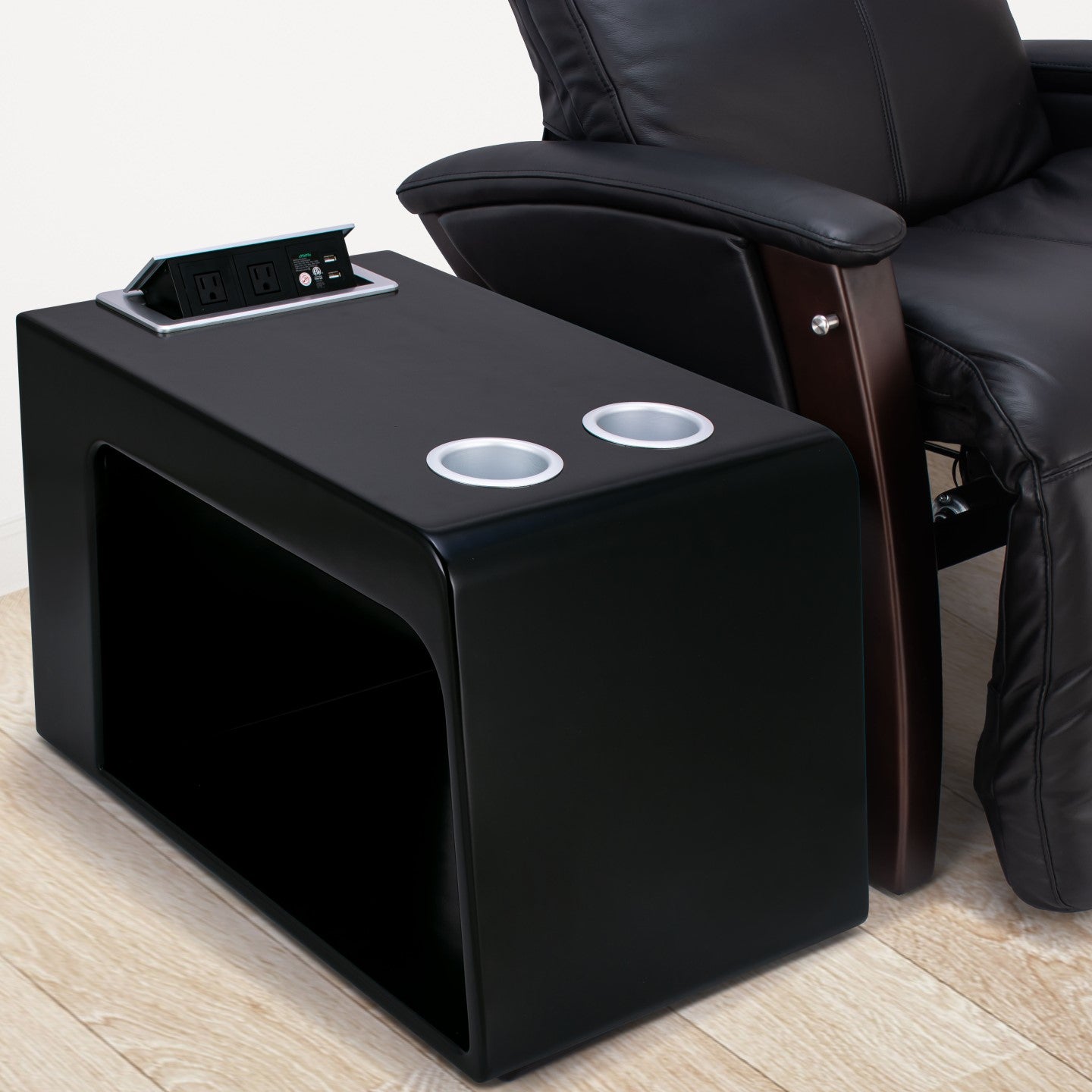 black zero gravity chair next to black Svago side table with cup holders and open USB charging station